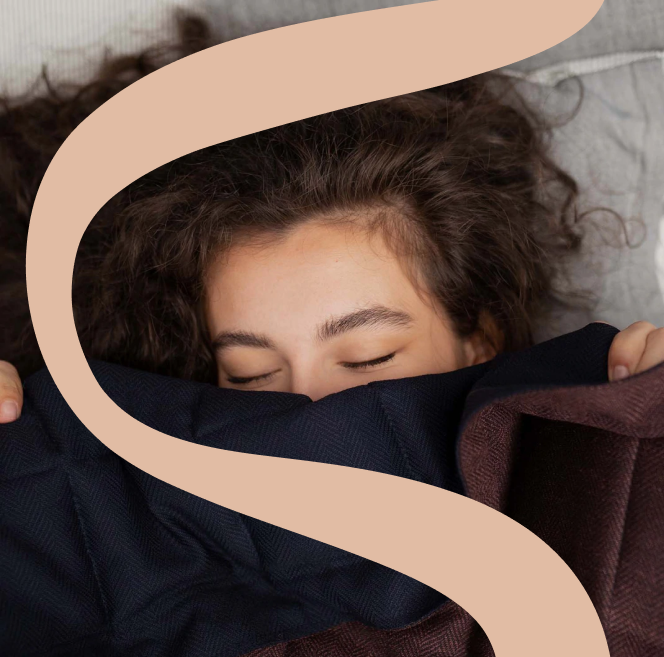 Picture of KNUS Merino Wool weighted blanket with KNUS logo overlay showing a girl under blanket